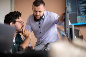 Programmers engrossed in deep collaboration, diligently working together to solve complex problems photo