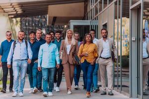 A diverse group of businessmen and colleagues walking together by their workplace, showcasing collaboration and teamwork in the company. photo