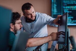 Programmers engrossed in deep collaboration, diligently working together to solve complex problems and develop innovative mobile applications with seamless functionality. photo