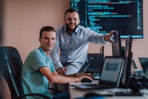 Programmers engrossed in deep collaboration, diligently working together to solve complex problems and develop innovative mobile applications with seamless functionality. photo