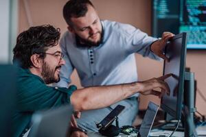 Programmers engrossed in deep collaboration, diligently working together to solve complex problems and develop innovative mobile applications with seamless functionality. photo