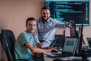 Programmers engrossed in deep collaboration, diligently working together to solve complex problems and develop innovative mobile applications with seamless functionality. photo