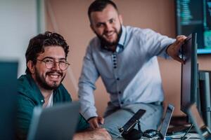 Programmers engrossed in deep collaboration, diligently working together to solve complex problems and develop innovative mobile applications with seamless functionality. photo
