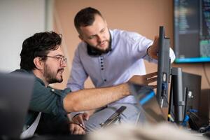 Programmers engrossed in deep collaboration, diligently working together to solve complex problems photo