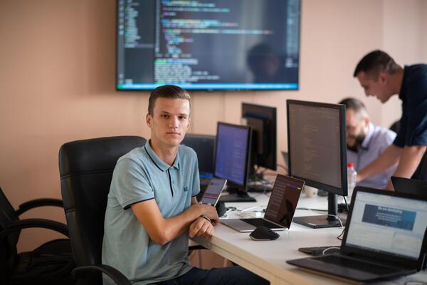 Innovating the Future. A Young Programmer Testing New Smartphone Apps in the Office.