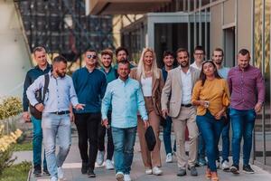A diverse group of businessmen and colleagues walking together by their workplace, showcasing collaboration and teamwork in the company. photo