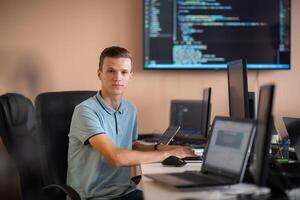Innovating the Future. A Young Programmer Testing New Smartphone Apps in the Office. photo