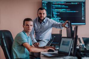 Programmers engrossed in deep collaboration, diligently working together to solve complex problems and develop innovative mobile applications with seamless functionality. photo