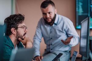 Programmers engrossed in deep collaboration, diligently working together to solve complex problems and develop innovative mobile applications with seamless functionality. photo
