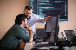 Programmers engrossed in deep collaboration, diligently working together to solve complex problems photo