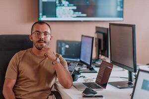 A programmer diligently testing smartphone applications while sitting in their office. photo