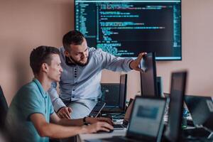 Programmers engrossed in deep collaboration, diligently working together to solve complex problems and develop innovative mobile applications with seamless functionality. photo