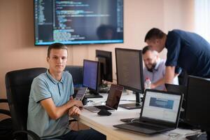 Innovating the Future. A Young Programmer Testing New Smartphone Apps in the Office. photo