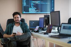 A programmer diligently testing smartphone applications photo