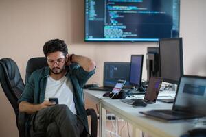 A programmer diligently testing smartphone applications photo