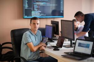 Innovating the Future. A Young Programmer Testing New Smartphone Apps in the Office. photo