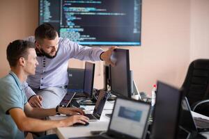 Programmers engrossed in deep collaboration, diligently working together to solve complex problems photo