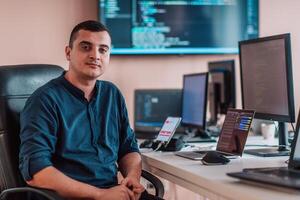 A programmer diligently testing smartphone applications while sitting in their office. photo