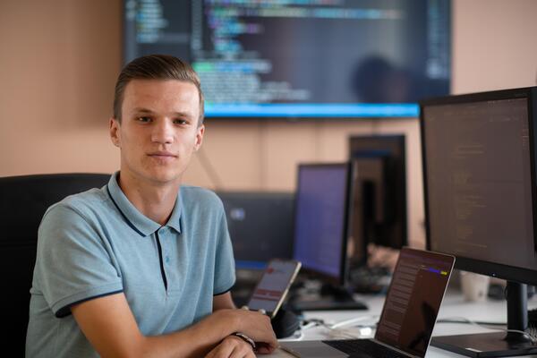 Innovating the Future. A Young Programmer Testing New Smartphone Apps in the Office.