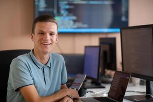 Innovating the Future. A Young Programmer Testing New Smartphone Apps in the Office. photo