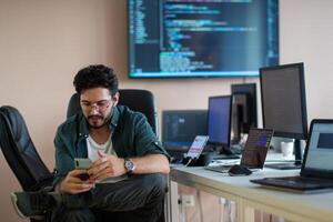 A programmer diligently testing smartphone applications photo