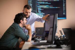 Programmers engrossed in deep collaboration, diligently working together to solve complex problems photo