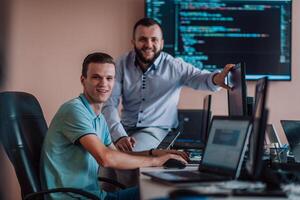 Programmers engrossed in deep collaboration, diligently working together to solve complex problems and develop innovative mobile applications with seamless functionality. photo