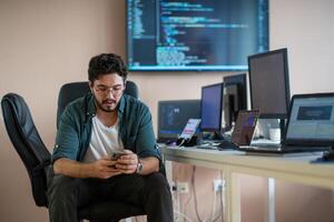 A programmer diligently testing smartphone applications photo