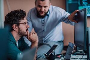 Programmers engrossed in deep collaboration, diligently working together to solve complex problems and develop innovative mobile applications with seamless functionality. photo