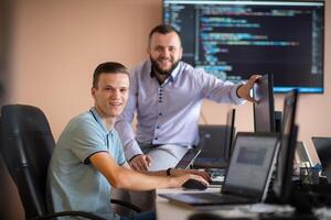 Programmers engrossed in deep collaboration, diligently working together to solve complex problems photo