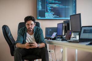 A programmer diligently testing smartphone applications photo