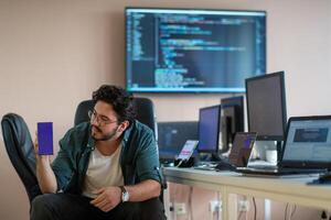 A programmer diligently testing smartphone applications photo