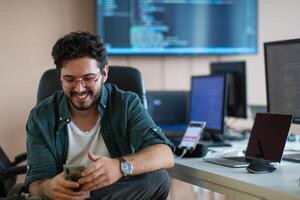 A programmer diligently testing smartphone applications photo