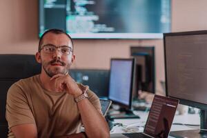 A programmer diligently testing smartphone applications while sitting in their office. photo