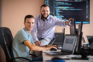 Programmers engrossed in deep collaboration, diligently working together to solve complex problems photo