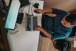 Top view of programmer diligently testing smartphone applications while sitting in their office. photo