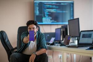 A programmer diligently testing smartphone applications photo