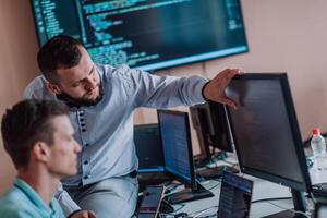 Programmers engrossed in deep collaboration, diligently working together to solve complex problems and develop innovative mobile applications with seamless functionality. photo