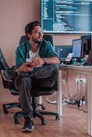 A programmer diligently testing smartphone applications while sitting in their office. photo