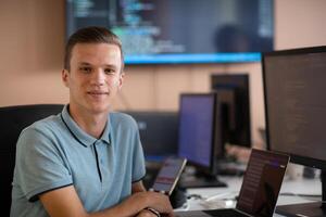 Innovating the Future. A Young Programmer Testing New Smartphone Apps in the Office. photo
