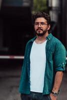 A portrait of a modern man, exuding confidence and style, against an outdoor backdrop, showcasing his charisma and fashionable demeanor. photo