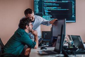 Programmers engrossed in deep collaboration, diligently working together to solve complex problems and develop innovative mobile applications with seamless functionality. photo