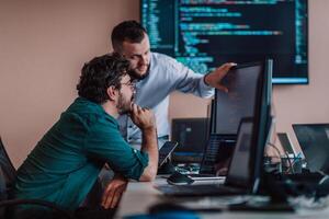 Programmers engrossed in deep collaboration, diligently working together to solve complex problems and develop innovative mobile applications with seamless functionality. photo
