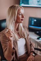 A businesswoman sitting in a programmer's office surrounded by computers, showing her expertise and dedication to technology. photo