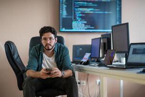 A programmer diligently testing smartphone applications photo