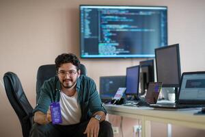 A programmer diligently testing smartphone applications photo