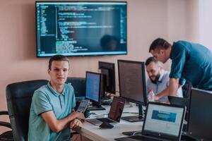 Programmers engrossed in deep collaboration, diligently working together to solve complex problems and develop innovative mobile applications with seamless functionality. photo