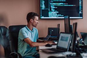 A programmer diligently testing smartphone applications while sitting in their office. photo