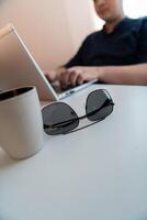 Close-up photo of a programmer typing on a laptop