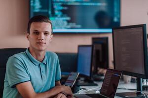 A programmer diligently testing smartphone applications while sitting in their office. photo